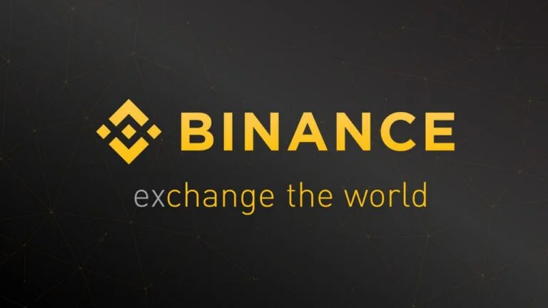 Logo Binance ze złotym symbolem i tagline'em "exchange the world" na czarnym tle