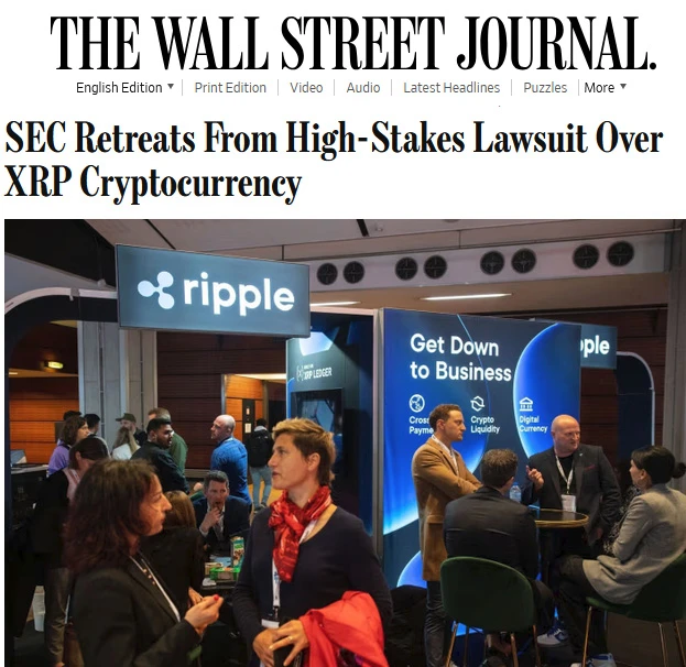 Stoisko Ripple na konferencji z uczestnikami rozmawiającymi w tle